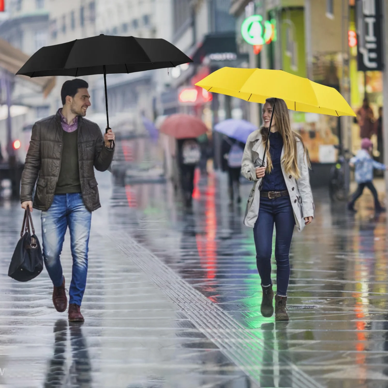 Two people under separate umbrellas on a wet city street