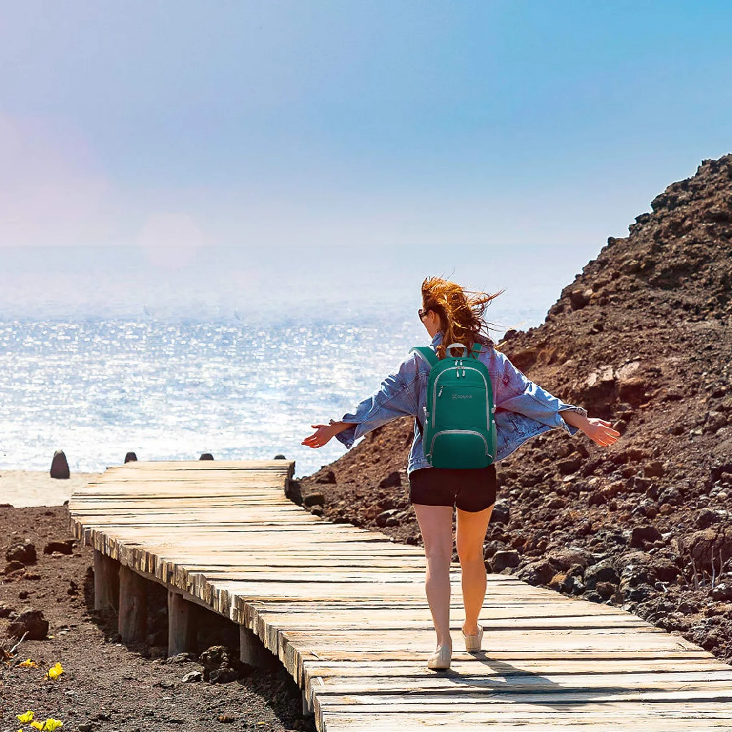 A walker on a boardwalk with a packable daypack